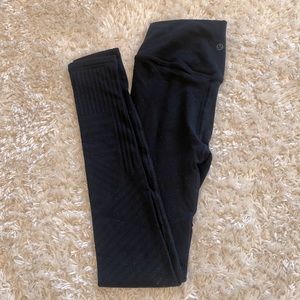 Lululemon black tights with laser cut pattern from thigh down
